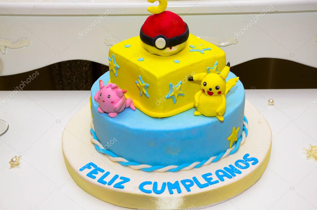Colorful kids birthday cake decorated with yellow cartoon characters.