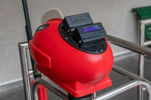 Contactless input. Entry with a travel card application. Automatic checkpoint with contactless payment access. Red Turnstile with card reader. Electronic checkpoint close-up