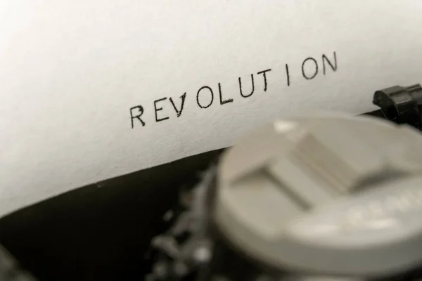 Close up printed text Revolution on an old typewriter