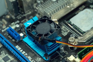 Usta elektrik süpürgesini ana kartın soğutma vantilatörüne getiriyor soğutucu dönüyor ve bilgisayarı tozdan temizliyor. Elektrik süpürgesiyle bilgisayar vantilatörünü temizliyorum..