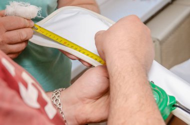 İşçiler asılmış bir tavan kurar, boruların altında yakın plan bir delik açar.