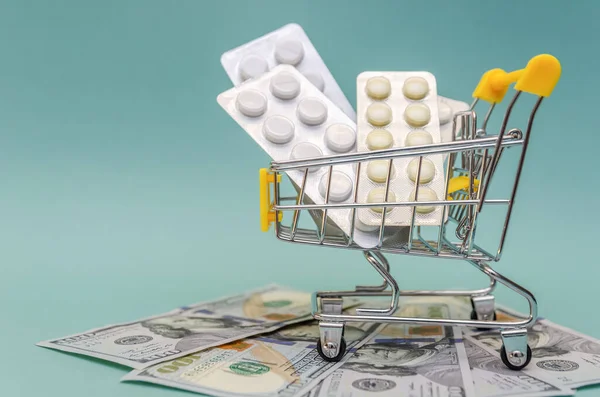 Yellow Shopping Cart Pills Stands Dollar Bills Blue Background Close — Stock Photo, Image