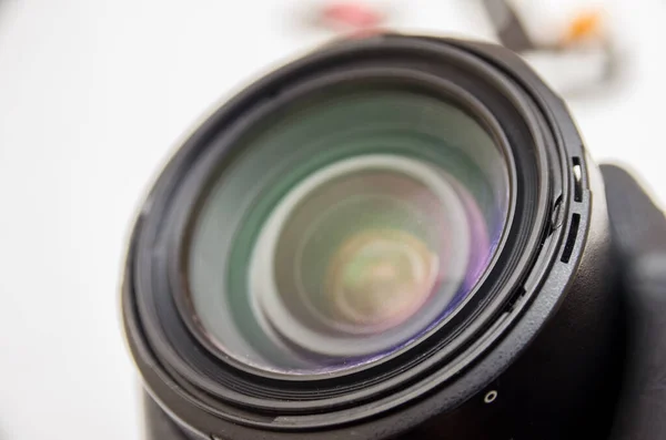 Photo lens or video lens close up on white background, goal, concept for photographer, cameraman, job, search for photographer, journalist, videographer for work. Photo lens repair