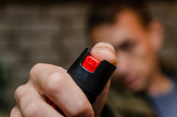 Man holding pepper spray for self defense close up