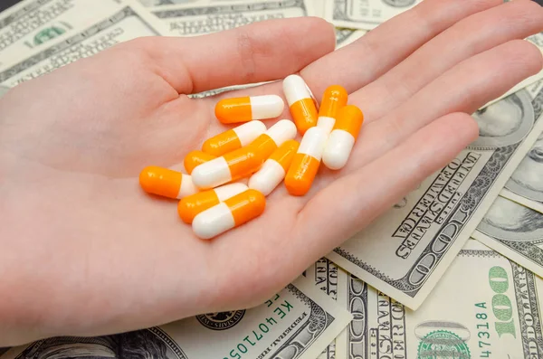 Oranje Witte Pillen Hand Tegen Achtergrond Van Dollars Veel Psychedelische — Stockfoto