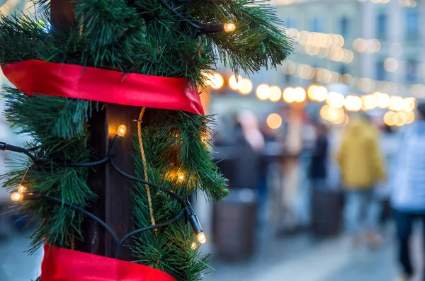 Christmas street decorations - Christmas lights, red ribbon, fir