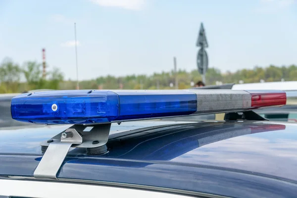 Close-up of flashing lights on a police car. Police flashing car roof lights outdoors. Top police patrol car with flasher and antennas