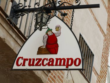 Seville, İspanya - 6 Nisan 2015: Sevilla, İspanya 'da duvara asılan tabela,' Cruzcampo 'adlı İspanyol birasının reklamı