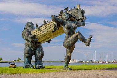 Kuressaare city, Saaremaa island, Estonia - July 12, 2018: Sightseeing of Saaremaa island. Statues of folk Estonian characters Suur Toll and Pirate in Kuressaare. clipart
