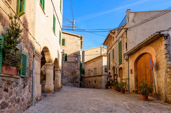 Mallorca island, Spain - January 4, 2019: Colorful street with stone buildings in the old town of Valldemossa