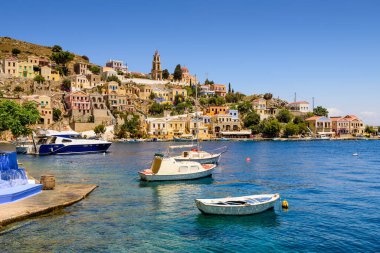 Suriye adası, Dodecanese Adaları, Yunanistan - 18 Mayıs 2016: Parlak ve renkli balıkçı tekneleriyle Yunanistan 'ın Symi adasındaki manzara kıyısı