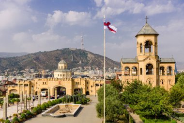 Tiflis, Gürcistan - 23 Eylül 2017: Gürcistan bayrağı ile Tiflis silueti, Tsminda Sameba Katedrali