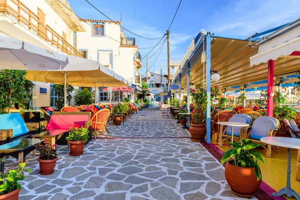 Samos Adası, Yunanistan - 24 Mayıs 2017: Kokkari köyünde açık hava restoranları olan renkli bir cadde. Kokkari köyü Samos adasında popüler bir turistik yerdir..