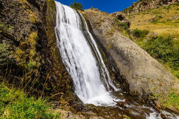 Artsci waterfall - a beautiful waterfall and natural landmark near Stepantsminda (Kazbegi) village, Caucasus mountains, Georgia