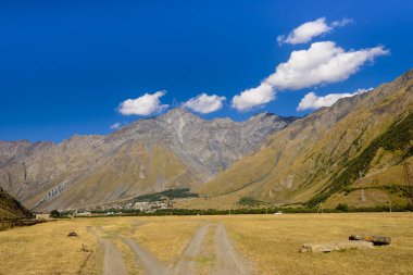 Gürcistan 'ın Kazbegi (Stepantsminda) köyü yakınlarında mavi gökyüzü olan güzel dağ manzarası