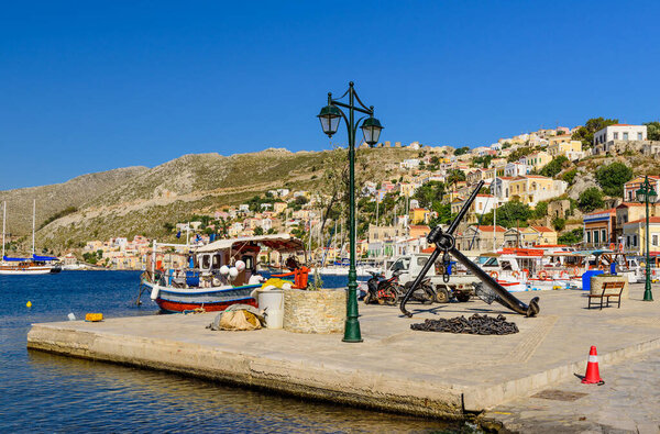 Symi island, Dodecanese Islands, Greece - May 18, 2016: Scenic waterfront on the Greek island of Symi with bright and colorful fishing boats