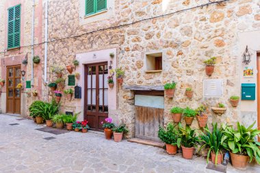 Mallorca Adası, Balearic Adaları, İspanya - 4 Ocak 2019: Valldemossa eski kasabasında çiçeklerle süslenmiş taş binalarla dolu güzel bir cadde