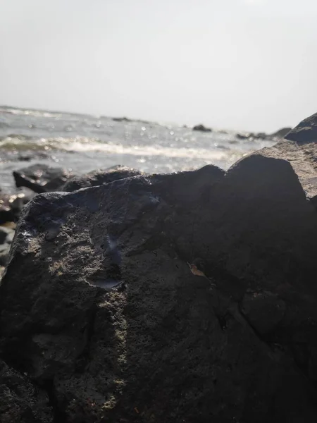 Hindistan Kunkunkunkuneshwar Konkan Maharashtra 'da Arap denizinin güzel deniz suyuyla kumsaldaki taşlar.