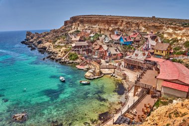 Beautiful scenery from the Popeye Village also known as Sweethaven Village. It is a purpose-built film set village that has been converted into a small attraction fun park, consisting of a collection of rustic and ramshackle wooden buildings in Malta clipart