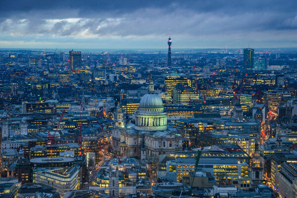Aerial photohtaphy over urban London. Modern architectural buildings and panoramic aerial view against a cloudy sky.