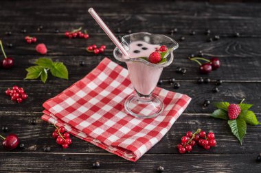 Ahududu farklı meyve ahşap bir zemin üzerine bir bardak dan güler yüzlü. Arka plan olarak kullanılabilir