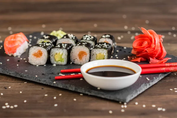 Fresh and tasty sushi on dark background. It can be used as a background