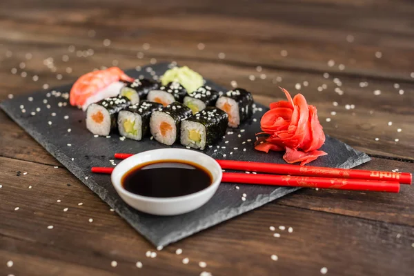 Fresh and tasty sushi on dark background. It can be used as a background