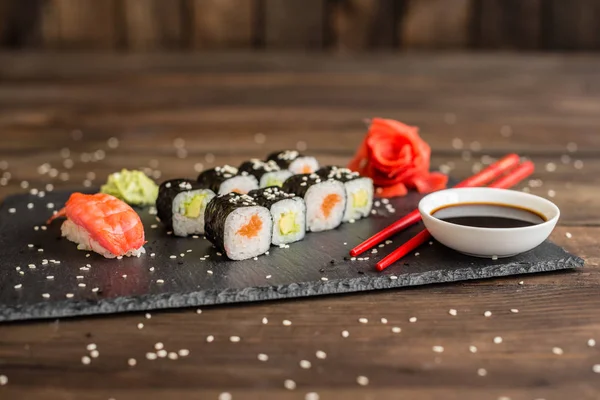 Fresh and tasty sushi on dark background. It can be used as a background