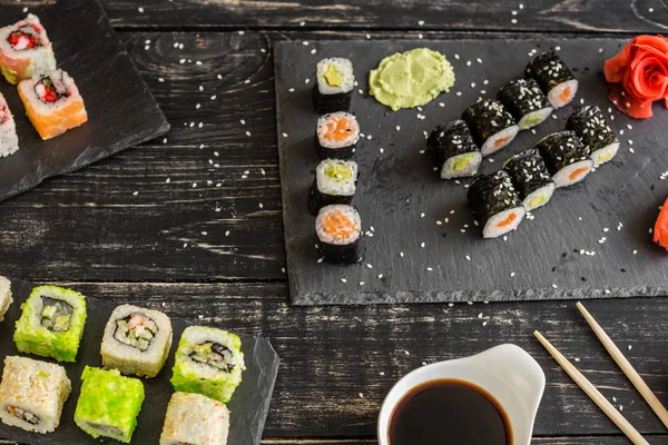 Fresh and tasty sushi on dark background. It can be used as a background