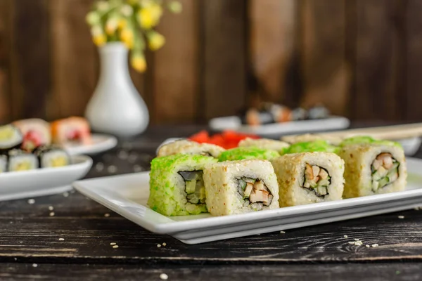 Fresh and tasty sushi on dark background. It can be used as a background