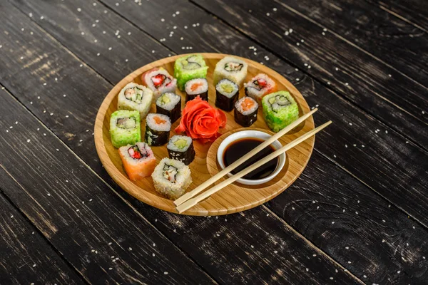 Fresh and tasty sushi on dark background. It can be used as a background