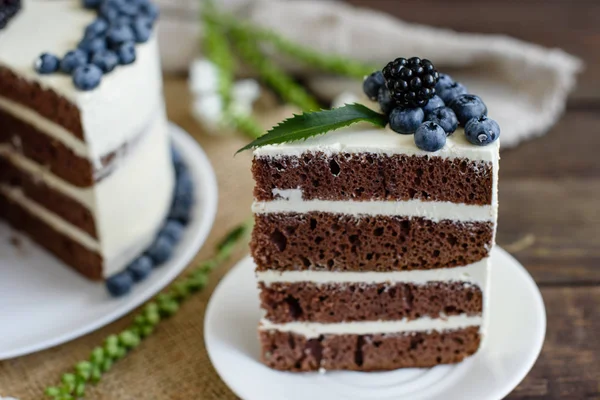 Beautiful tasty cake with white cream and berries of blueberry