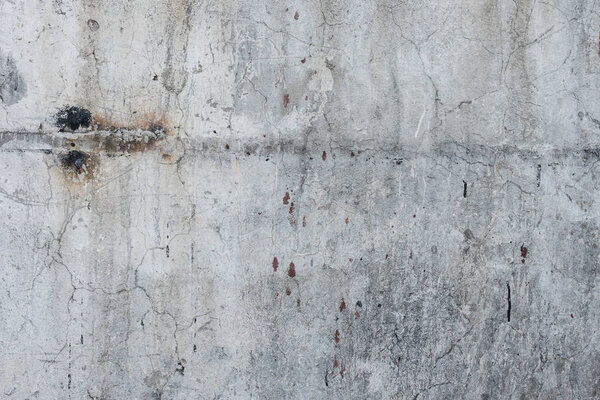 Фрагмент стены с царапинами и трещинами. Его можно использовать в качестве фона
