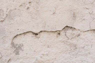 Çizikler ve çatlaklar ile duvar parçası. Arka plan olarak kullanılabilir