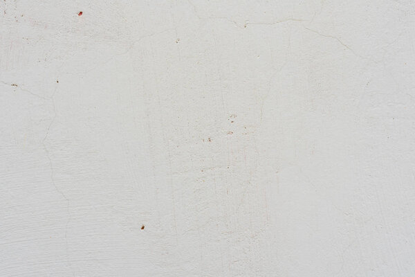 Фрагмент стены с царапинами и трещинами. Его можно использовать в качестве фона
