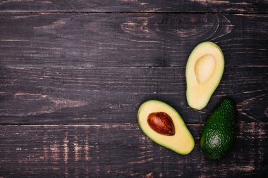 Gıda, avokado, sağlıklı gıda. Avokado karanlık bir arka plan karşı kesilmiş. Arka plan olarak kullanılabilir