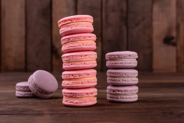 Wedding, St. Valentine's Day, birthday, preparation, holiday. Beautiful pink tasty macaroons on a concrete background