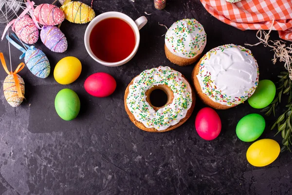 Easter, cake, eggs, holiday. Easter cake and colorful eggs on a dark background. It can be used as a background