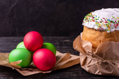Paskalya, pasta, yumurta, tatil. Paskalya kek ve karanlık bir arka plan üzerinde renkli yumurta. Arka plan olarak kullanılabilir
