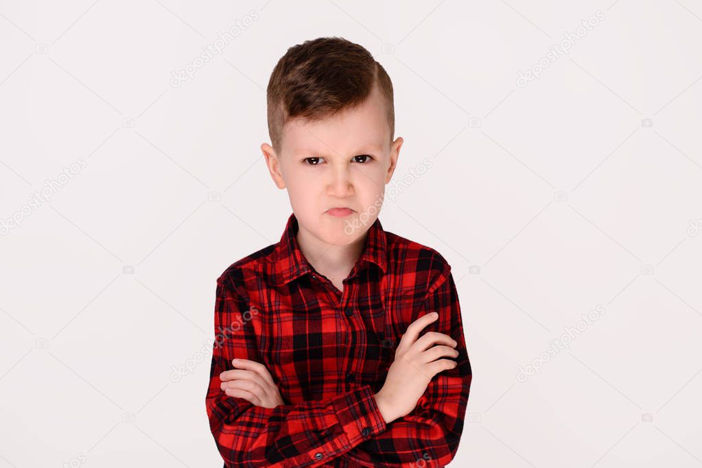 The little boy with expressive emotion on a white background. The isolated object
