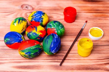 Paskalya çok renkli yumurta, boya ve fırça bir masada. Tatil için hazırlık