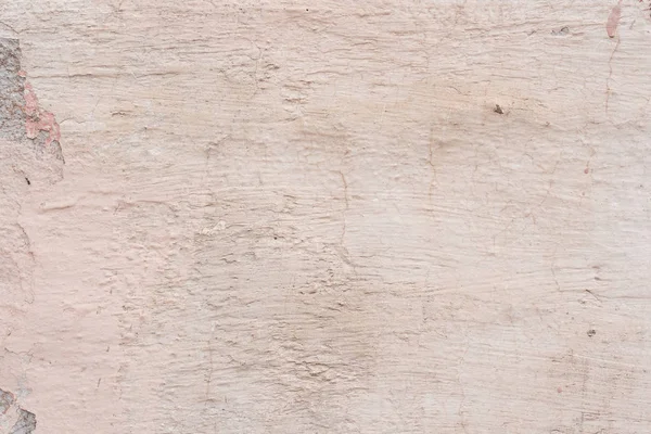 Çizik ve çatlaklarla dolu bir duvar parçası.