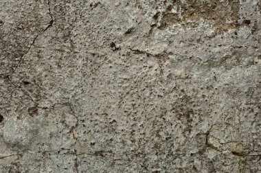 Çatlakları ve çizikleri olan beton bir duvarın dokusu arka plan olarak kullanılabilir.