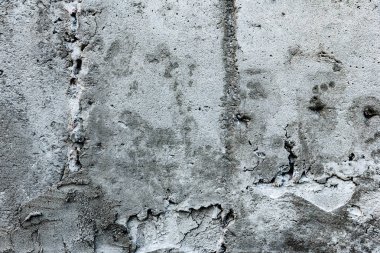 Çatlakları ve çizikleri olan beton bir duvarın dokusu arka plan olarak kullanılabilir.