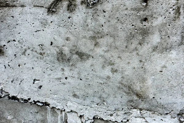 Çatlakları ve çizikleri olan beton bir duvarın dokusu arka plan olarak kullanılabilir.