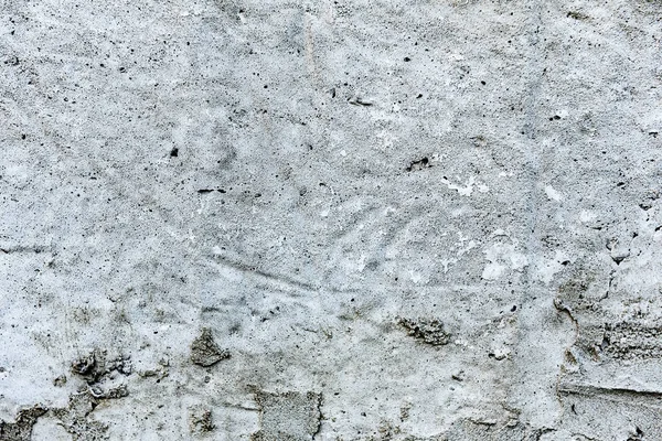 Çatlakları ve çizikleri olan beton bir duvarın dokusu arka plan olarak kullanılabilir.