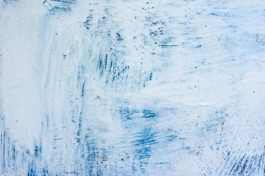 Çatlakları ve çizikleri olan beton bir duvarın dokusu arka plan olarak kullanılabilir.