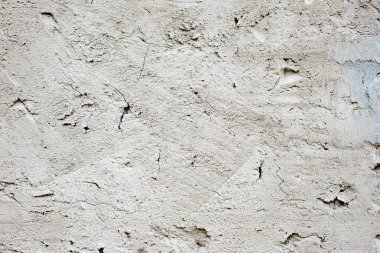 Çatlakları ve çizikleri olan beton bir duvarın dokusu arka plan olarak kullanılabilir.