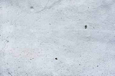 Çatlakları ve çizikleri olan beton bir duvarın dokusu arka plan olarak kullanılabilir.