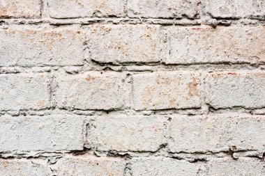 Çatlakları ve çizikleri olan tuğla duvar dokusu arka plan olarak kullanılabilir.